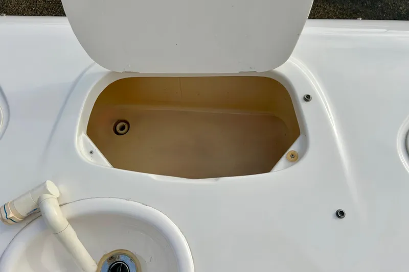 Slide: The Image of Open storage compartment on 2000 Chaparral Sunesta 233 boat deck. - 56