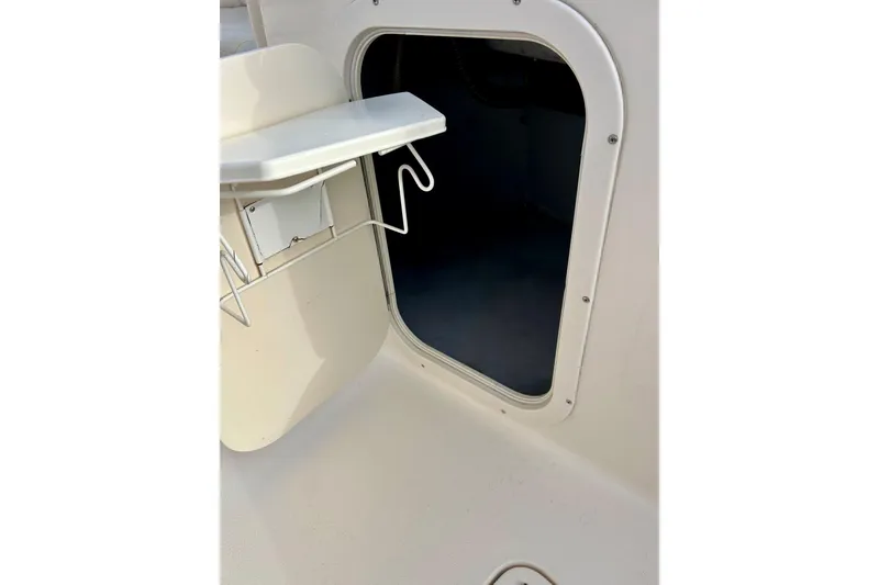 Slide: The Image of 2000 Chaparral Sunesta 233 boat interior hatch with storage compartment. - 61