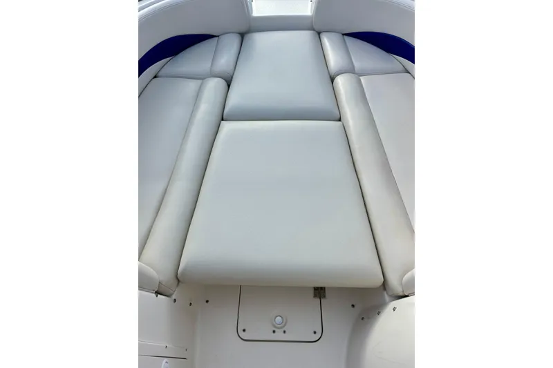 Slide: The Image of 2000 Chaparral Sunesta 233 boat interior with cushioned seating area. - 64