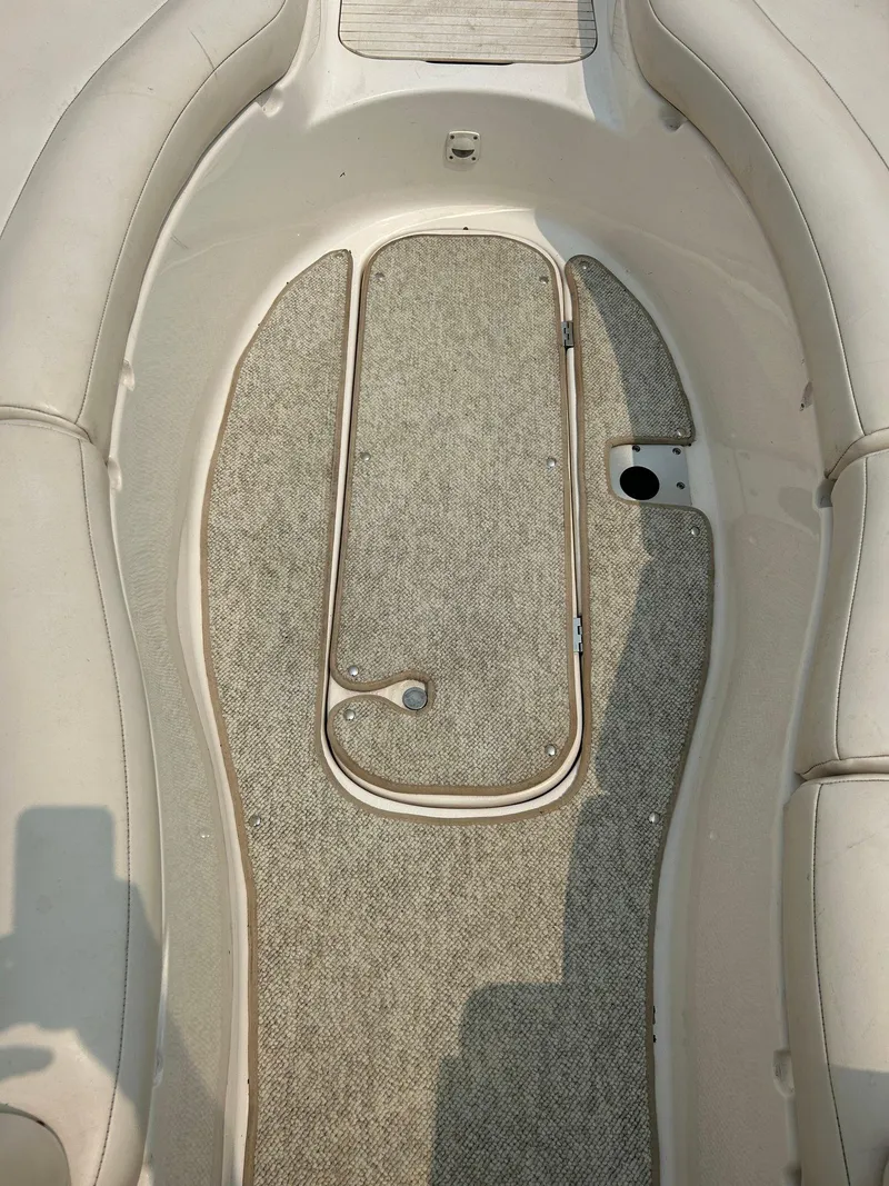 Slide: The Image of 2000 Chaparral Sunesta 233 boat interior with white and blue seating. - 9