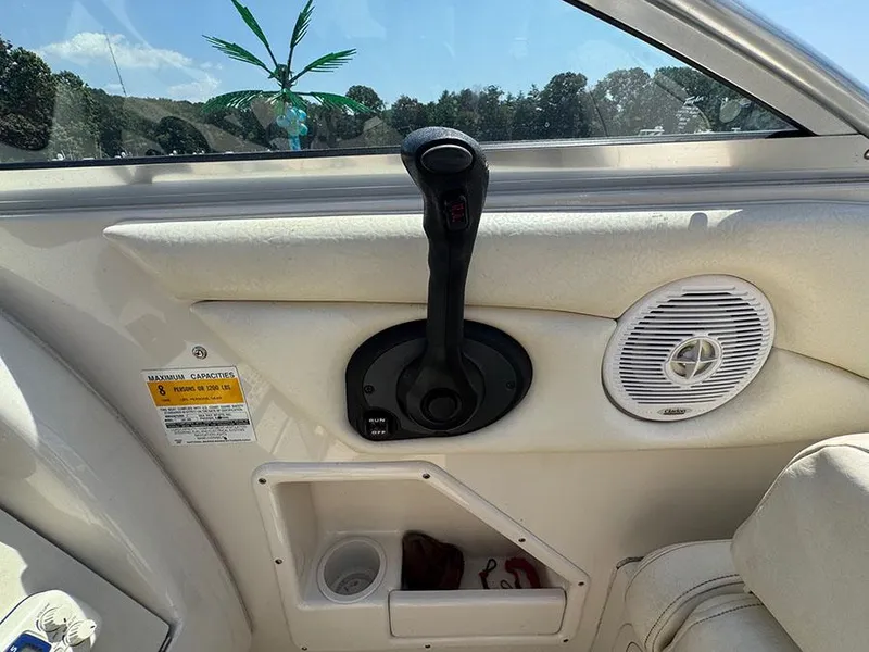 Slide: The Image of Interior of 2001 Sea Ray 245 Weekender boat with control lever and speaker. - 13