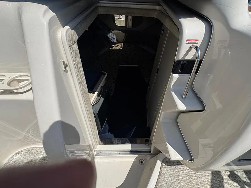 Slide: The Image of Interior cabin view of a 2001 Sea Ray 245 Weekender boat, showing entrance and seating area. - 16