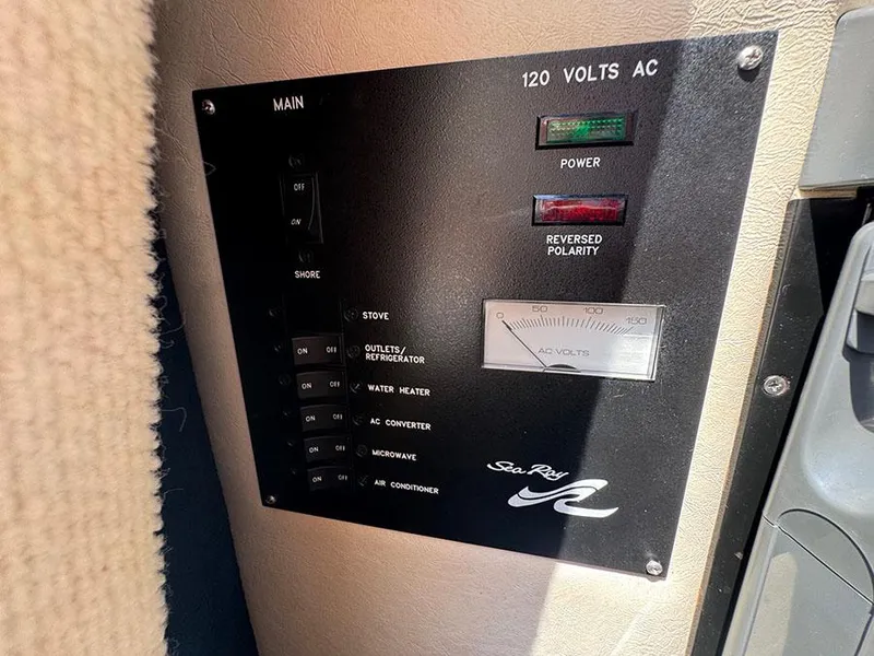 Slide: The Image of Electrical panel of a 2001 Sea Ray 245 Weekender boat, showing AC voltage controls. - 19