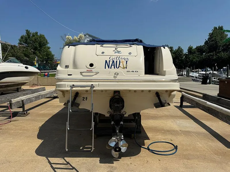 Slide: The Image of 2001 Sea Ray 245 Weekender boat on trailer, rear view with ladder and propeller. - 2