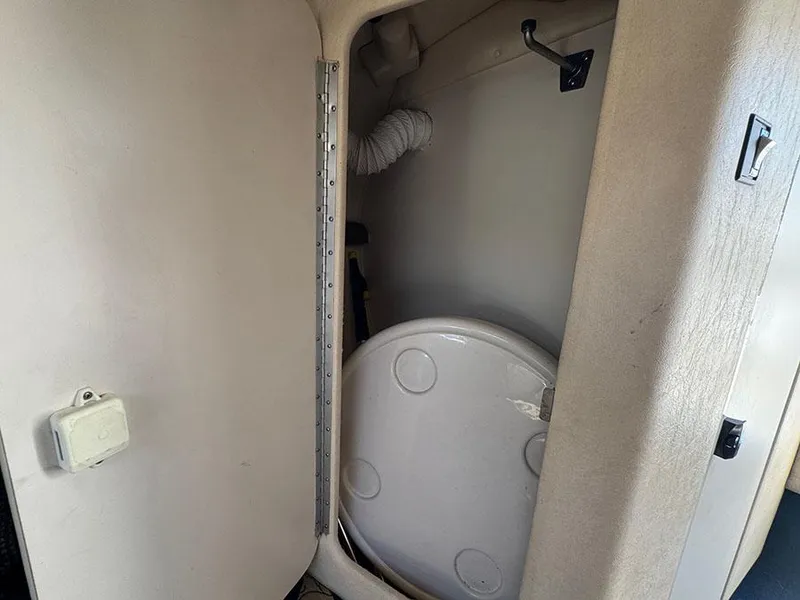 Slide: The Image of Interior of 2001 Sea Ray 245 Weekender showing compact bathroom space. - 21