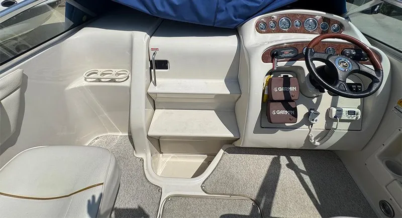 Slide: The Image of 2001 Sea Ray 245 Weekender boat interior with steering wheel and control panel. - 22