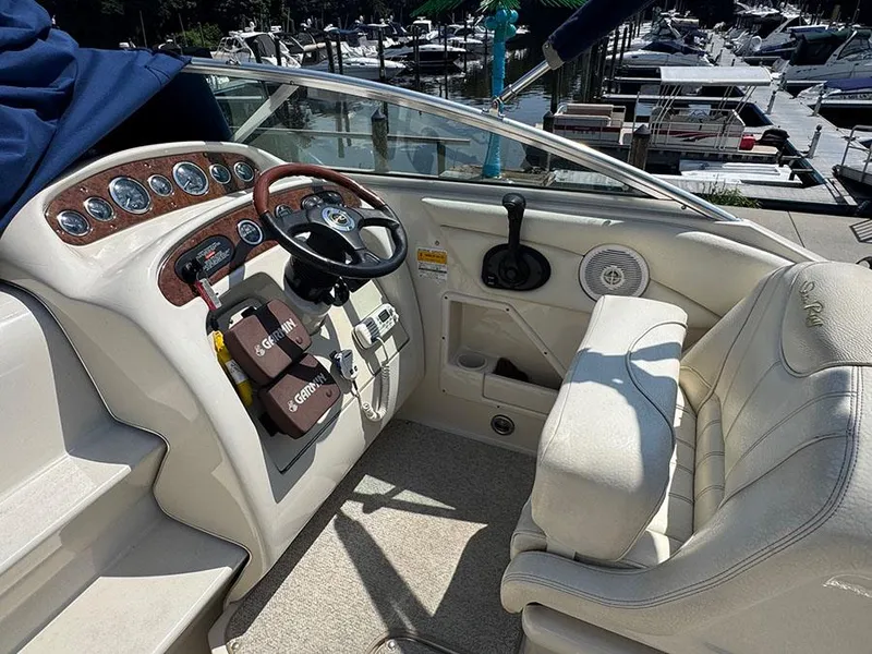 Slide: The Image of 2001 Sea Ray 245 Weekender boat cockpit with steering wheel and control panel. - 25