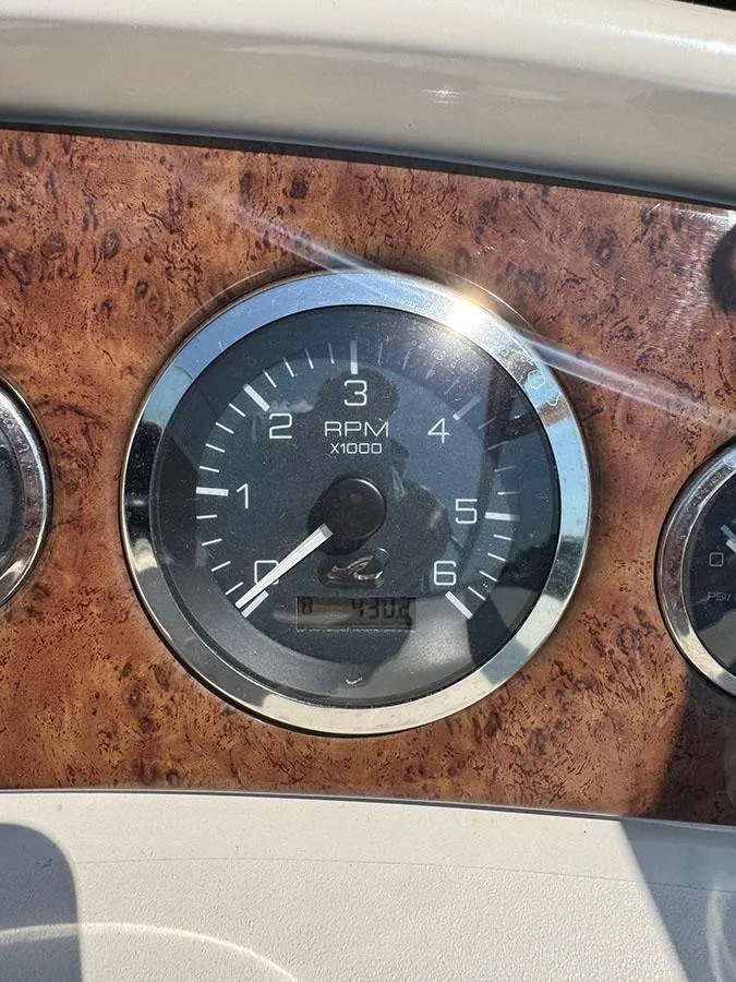 Slide: The Image of Close-up of a 2001 Sea Ray 245 Weekender RPM gauge on a wooden dashboard. - 8