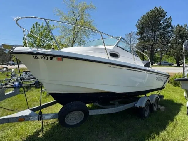 Slide: The Image of 2005 Boston Whaler 205 Eastport boat on trailer, parked on grass. - 3