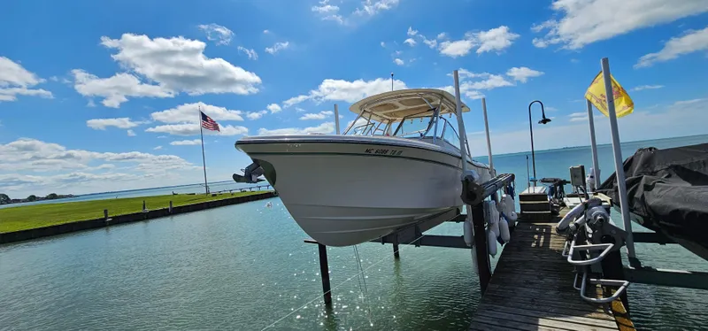 The Image of 2014 Grady-White Freedom 285 boat on dry dock under clear blue sky. - 0