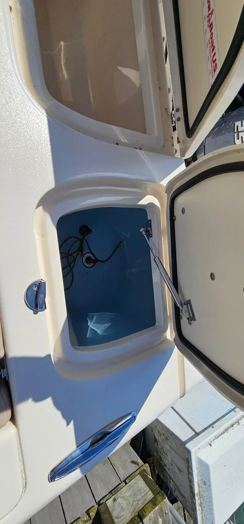 Slide: The Image of 2014 Grady-White Freedom 285 boat with open storage compartment and twin 250 engines. - 8