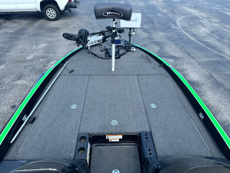 Slide: The Image of 2020 Triton 20 TRX Patriot boat deck with Garmin equipment, parked on asphalt. - 10