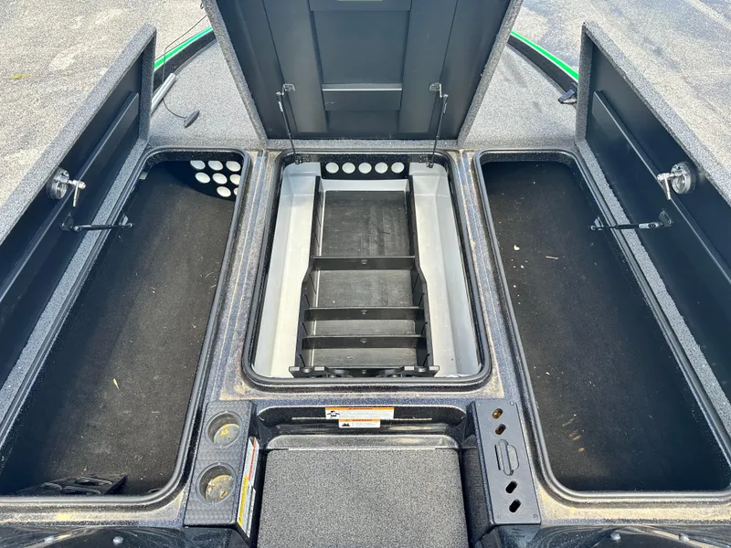 Slide: The Image of 2020 Triton 20 TRX Patriot boat storage compartments open, showcasing spacious interior design. - 14