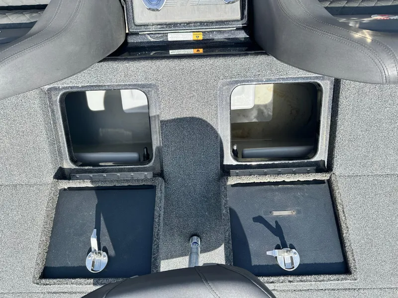 Slide: The Image of 2020 Triton 20 TRX Patriot boat storage compartments with open lids and secure latches. - 15