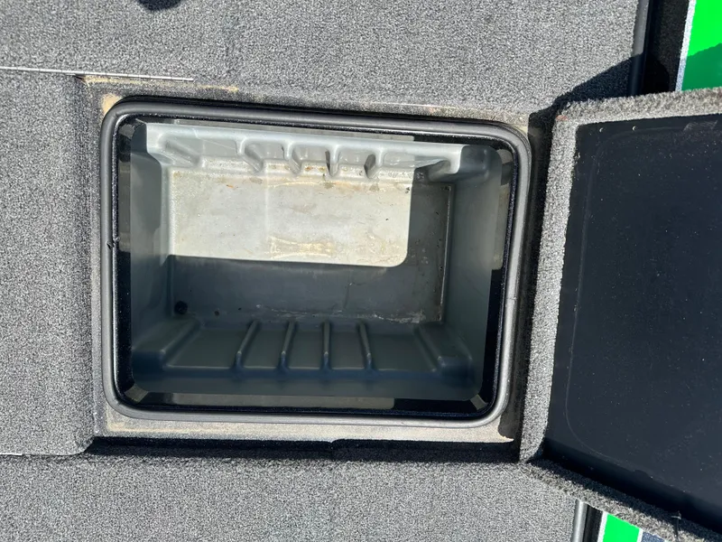 Slide: The Image of Open storage compartment on 2020 Triton 20 TRX Patriot boat. - 16