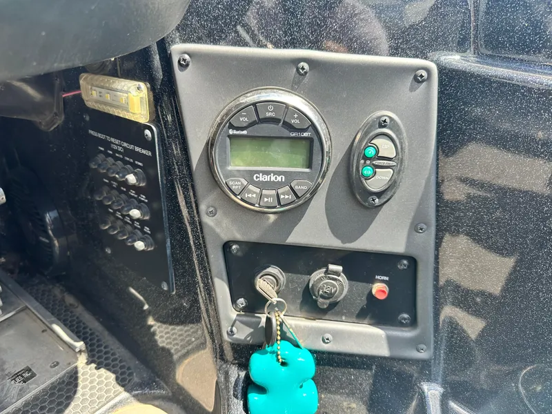 Slide: The Image of Control panel of a 2020 Triton 20 TRX Patriot boat with Clarion audio system. - 18