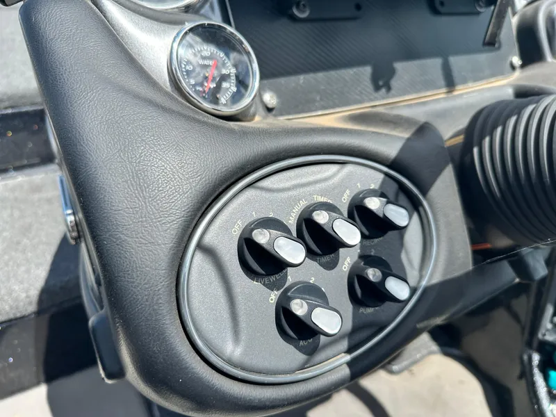 Slide: The Image of Control panel of 2020 Triton 20 TRX Patriot boat with switches and gauge. - 19