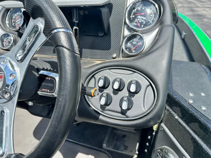 Slide: The Image of Dashboard of a 2020 Triton 20 TRX Patriot boat with steering wheel and control panel. - 20