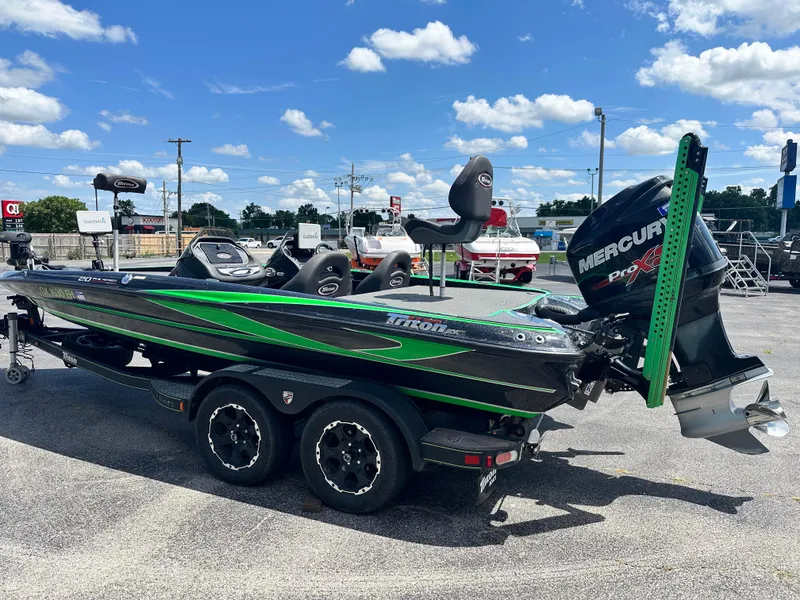 Slide: The Image of 2020 Triton 20 TRX Patriot boat with Mercury Pro XS engine, parked outdoors under blue sky. - 6