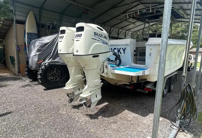 Slide: The Image of 1996 Pro-Line 27 CC boat with twin Suzuki 200 outboard motors in a covered storage area. - 10