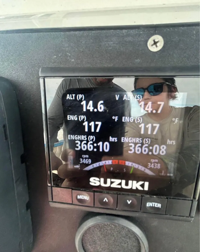 Slide: The Image of Dashboard of a 1996 Pro-Line 27 CC boat showing engine metrics on a Suzuki display. - 4