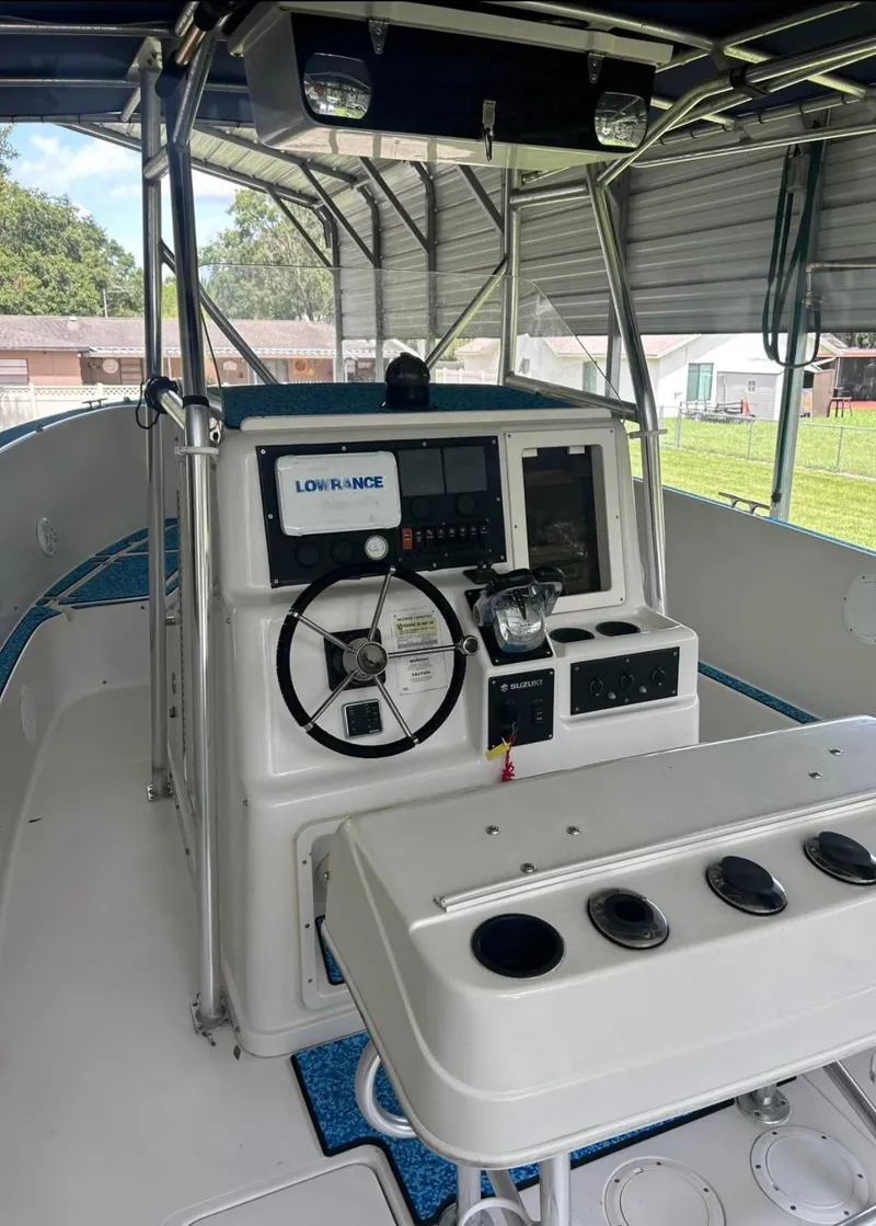 Slide: The Image of 1996 Pro-Line 27 CC boat interior with steering console and navigation equipment. - 9