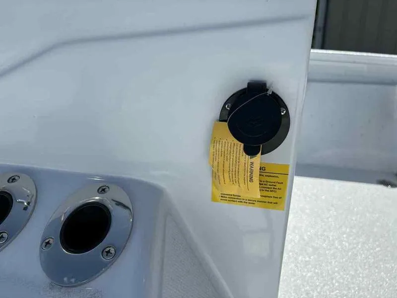 Slide: The Image of 2026 Xpress H22B boat detail showing rod holders and a warning label. - 11