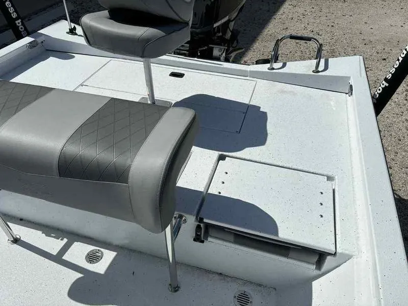 Slide: The Image of 2026 Xpress H22B boat interior with gray seating and storage compartments. - 13