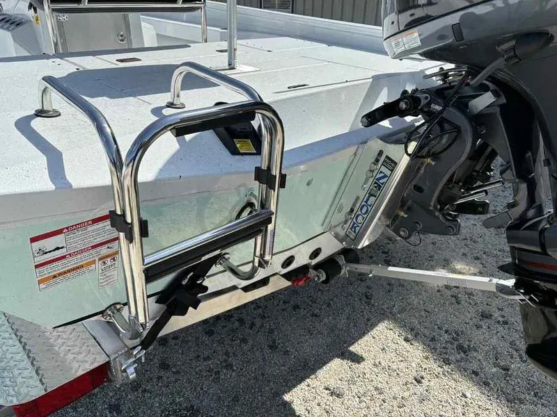 Slide: The Image of 2026 Xpress H22B boat with ladder and outboard motor on trailer. - 17