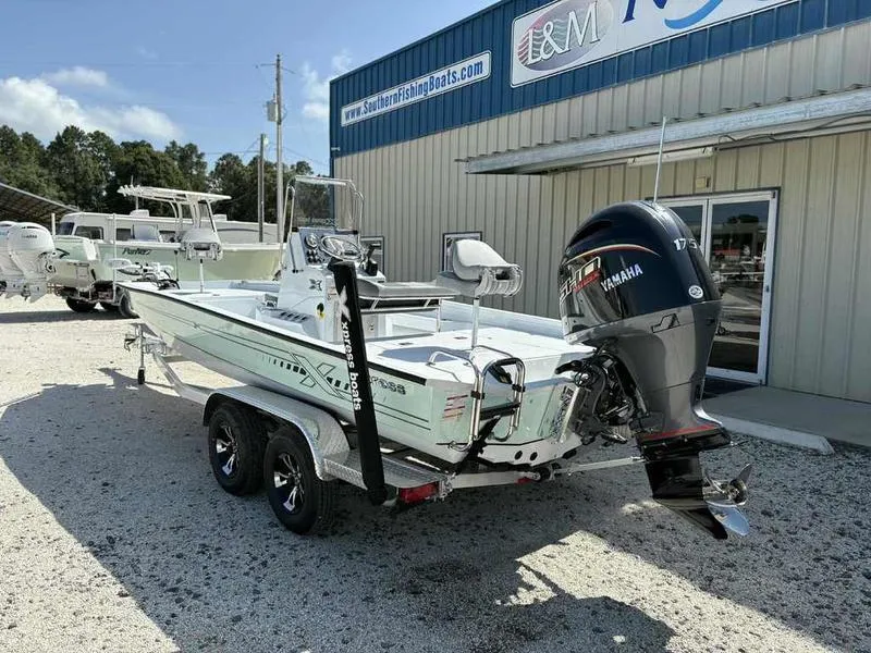 Slide: The Image of 2026 Xpress H22B boat with Yamaha engine on trailer outside dealership. - 3