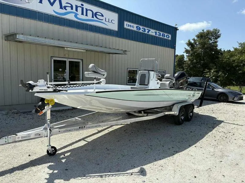 Slide: The Image of 2026 Xpress H22B boat on trailer outside marine dealership. - 4