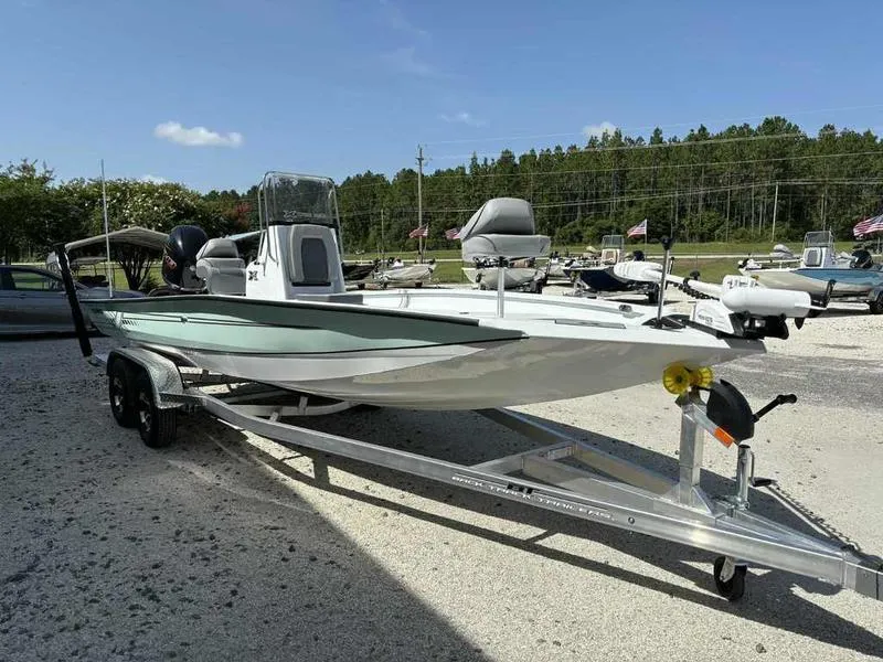 Slide: The Image of 2026 Xpress H22B boat on trailer, parked outdoors under clear sky. - 5