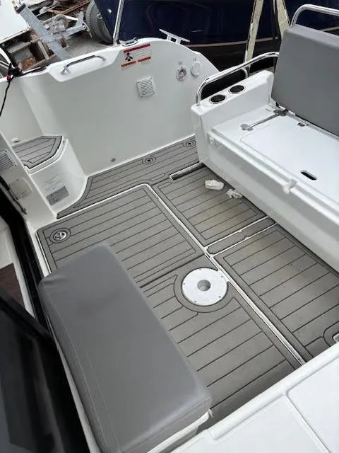 Slide: The Image of 2019 Beneteau Antares 27 boat deck with gray seating and non-slip flooring. - 10