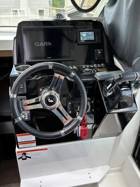 Slide: The Image of 2019 Beneteau Antares 27 helm with Garmin navigation system and steering wheel. - 16