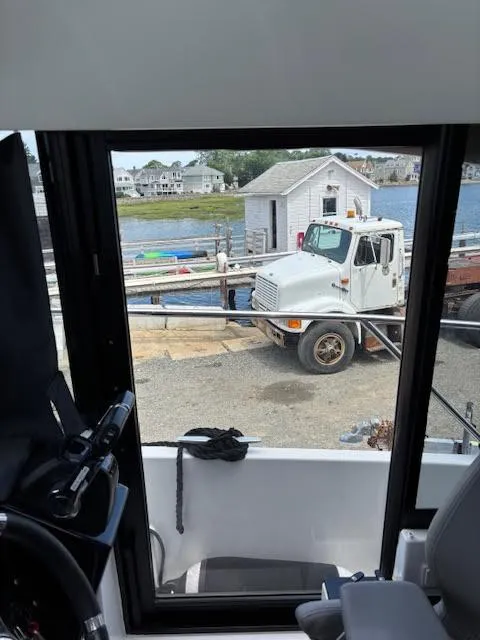 Slide: The Image of View from 2019 Beneteau Antares 27, overlooking a truck and waterfront scene. - 18