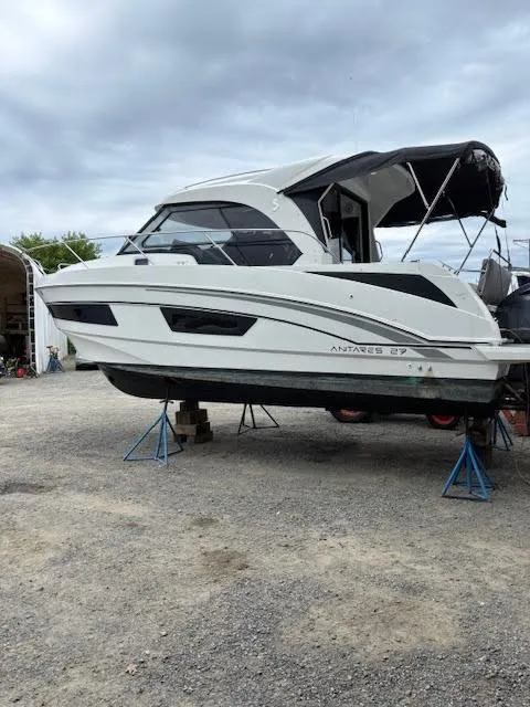 Slide: The Image of 2019 Beneteau Antares 27 boat on stands, overcast sky background. - 2