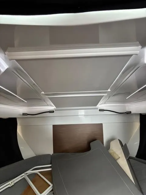 Slide: The Image of Interior view of 2019 Beneteau Antares 27 boat cabin with seating and storage. - 30