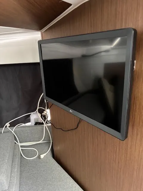 Slide: The Image of Flat-screen TV mounted in 2019 Beneteau Antares 27 cabin interior. - 31