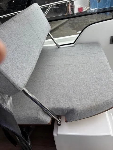 Slide: The Image of Gray cushioned seating on 2019 Beneteau Antares 27 boat, featuring sleek metal supports. - 35