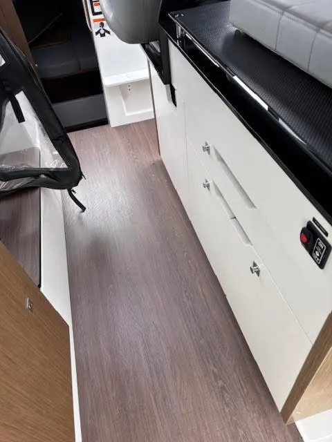 Slide: The Image of Interior view of 2019 Beneteau Antares 27, featuring sleek cabinetry and modern flooring. - 38