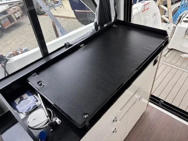Slide: The Image of Interior view of 2019 Beneteau Antares 27 boat with black countertop and storage cabinets. - 39