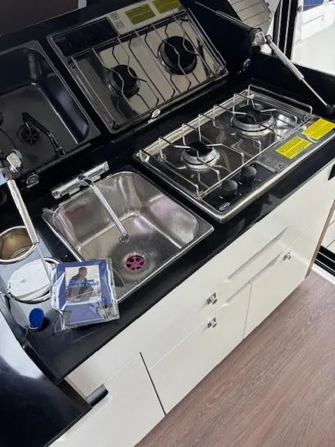 Slide: The Image of Compact kitchen area in a 2019 Beneteau Antares 27 boat with stove and sink. - 40
