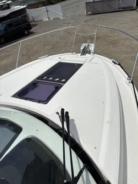 Slide: The Image of 2019 Beneteau Antares 27 boat deck with hatch, docked on land. - 44
