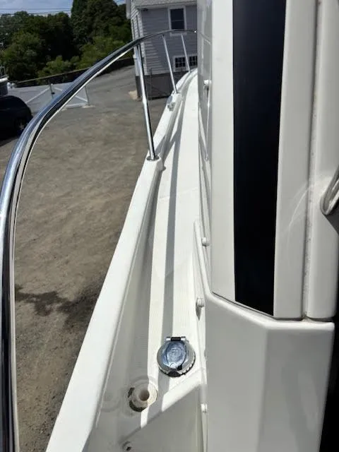 Slide: The Image of 2019 Beneteau Antares 27 boat deck with railing and hatch, docked outdoors. - 46