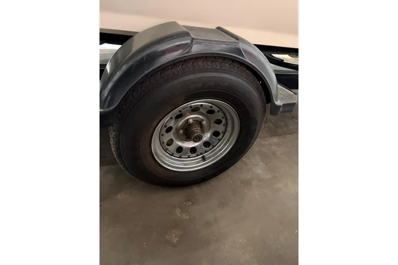 Slide: The Image of Trailer wheel of a 2007 Bombardier Sea-Doo Utopia 205, parked indoors. - 14