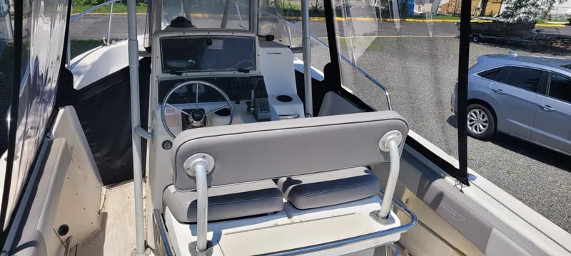 Slide: The Image of 2000 Boston Whaler 240 Outrage boat interior with steering console and seating. - 10