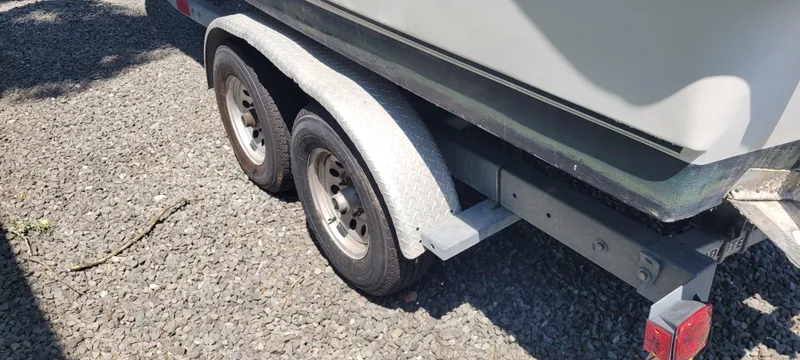 Slide: The Image of Trailer for 2000 Boston Whaler 240 Outrage on gravel surface. - 15