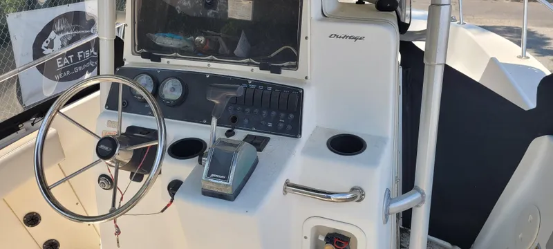 Slide: The Image of Boston Whaler 240 Outrage 2000 boat console with steering wheel and controls. - 4