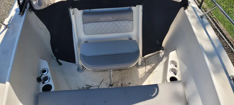 Slide: The Image of Boston Whaler 240 Outrage 2000 boat interior with seating and cup holders. - 7