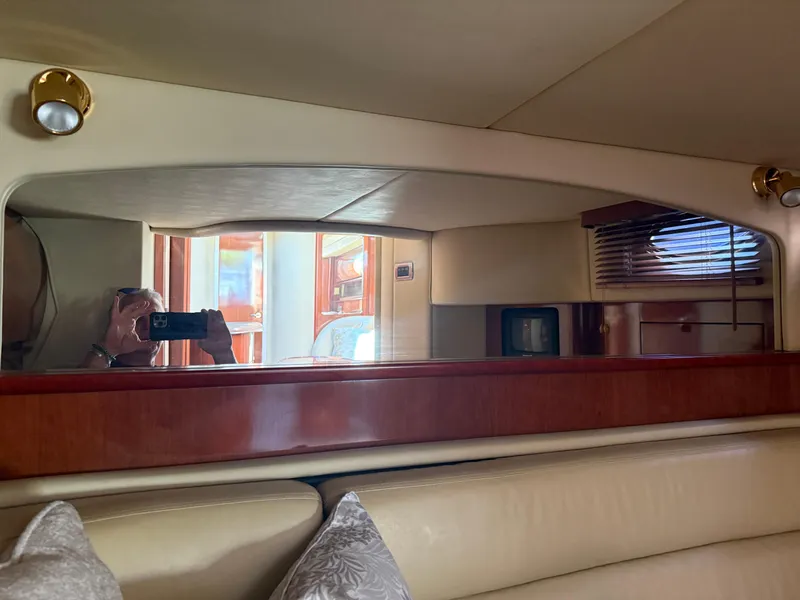 Slide: The Image of Interior of 2003 Sea Ray 420 Sundancer yacht with mirror and wooden accents. - 11